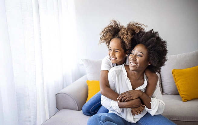 family in living room watching laptop