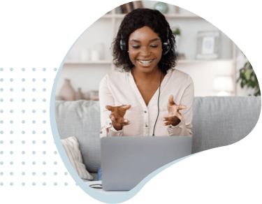 woman on headset in front of laptop