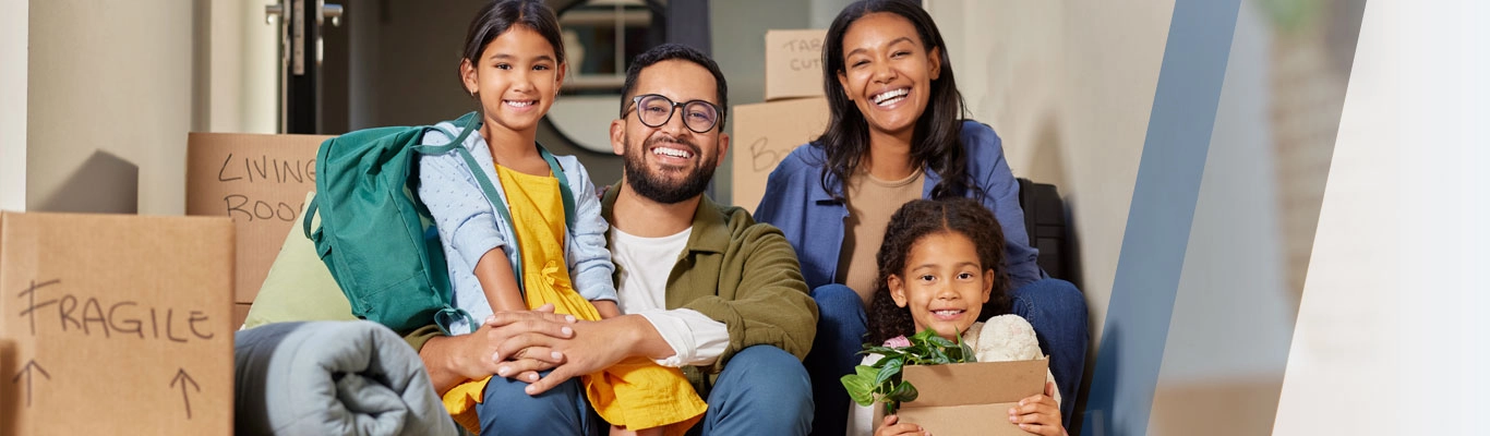 Family on porch with moving boxes