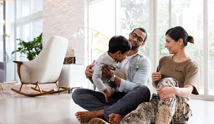 va family sitting on floor of living room.