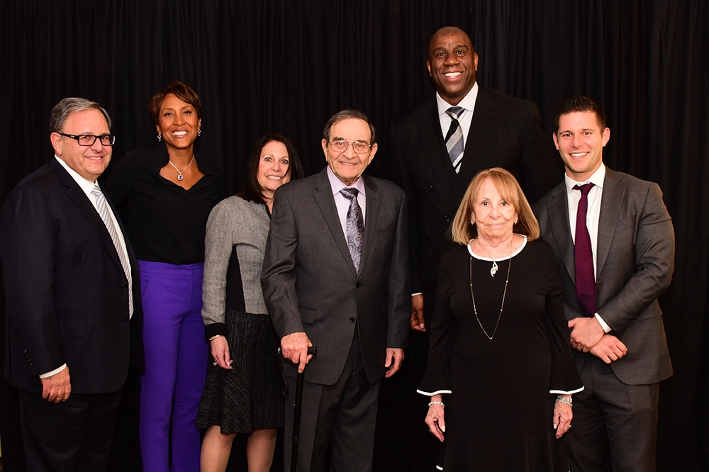 Stan, Roslyn, Lenny, Ronnie, and Michael with Robin Roberts, former anchor for ABC's Good Morning America, and Earvin "Magic" Johnson, Jr. Stan, Roslyn, Lenny, Ronnie, and Michael with Robin Roberts, former anchor for ABC's Good Morning America, and Earvin "Magic" Johnson, Jr.