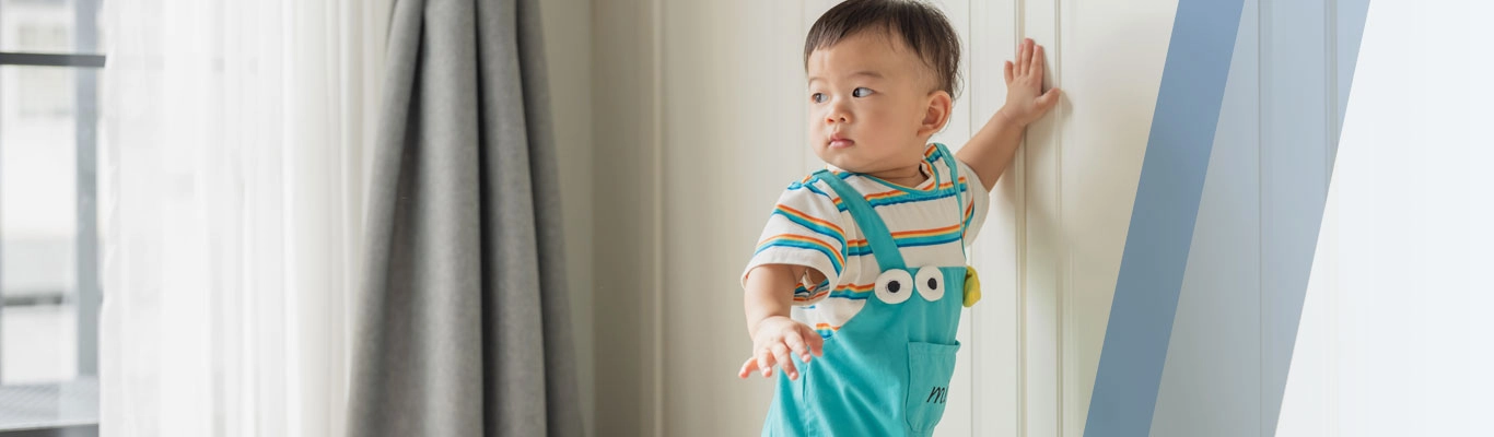 Asian baby in home kitchen